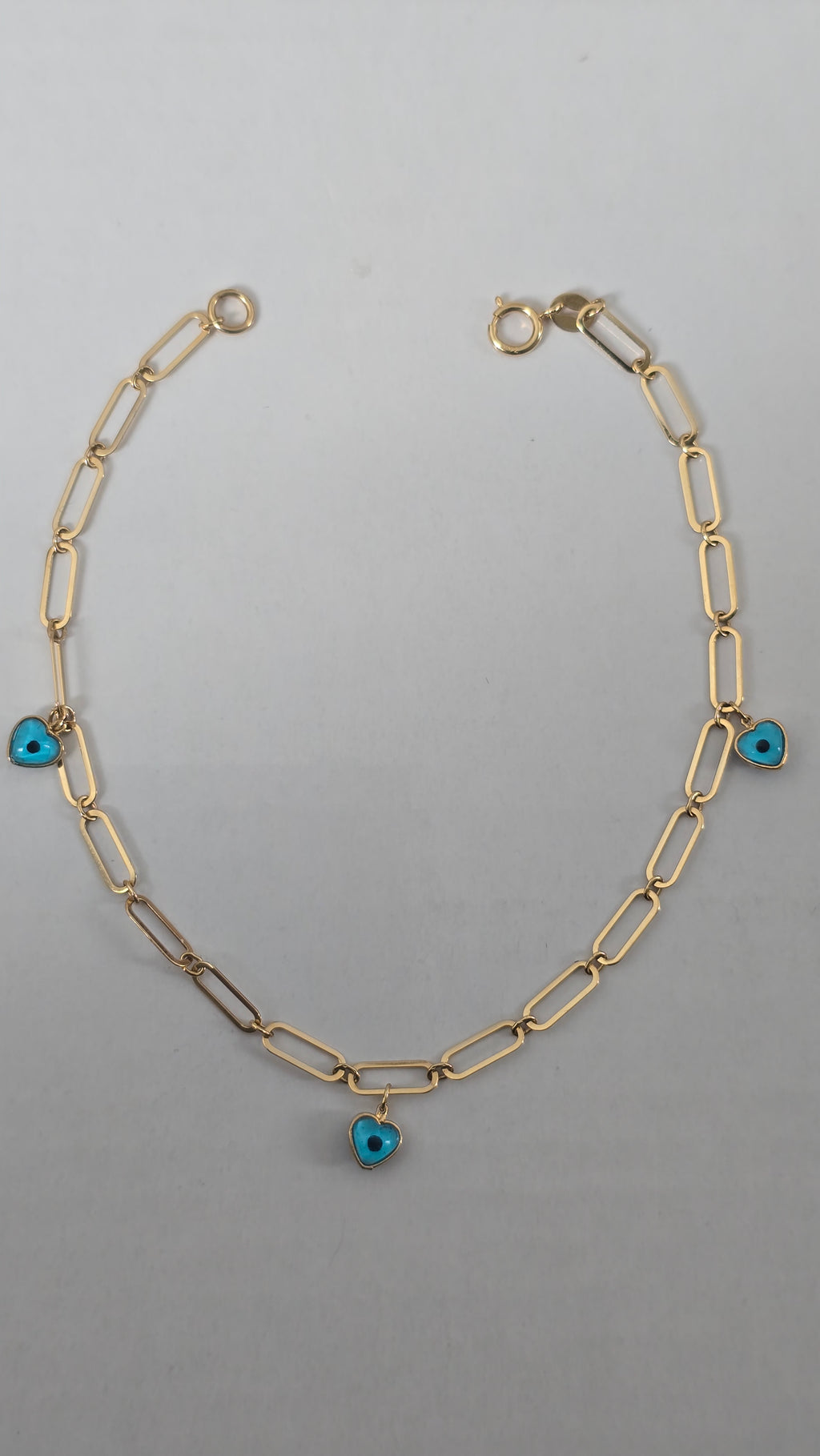 Pulsera de clip tejida con dije de corazón y ojo turco
