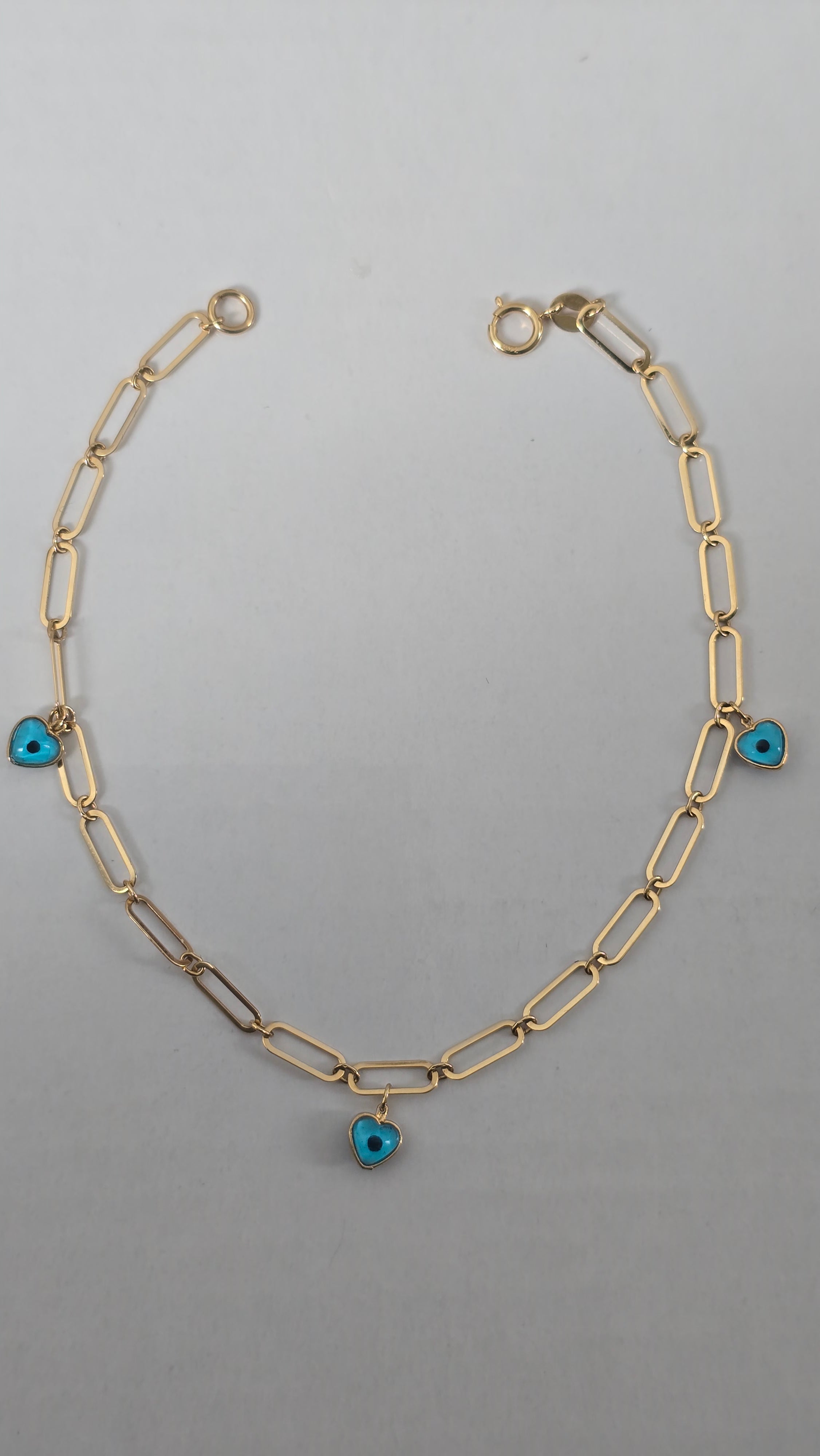 Pulsera de clip tejida con dije de corazón y ojo turco